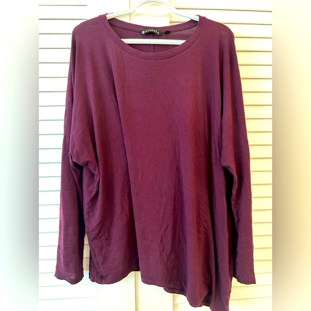 Knit top, with asymmetrical hem